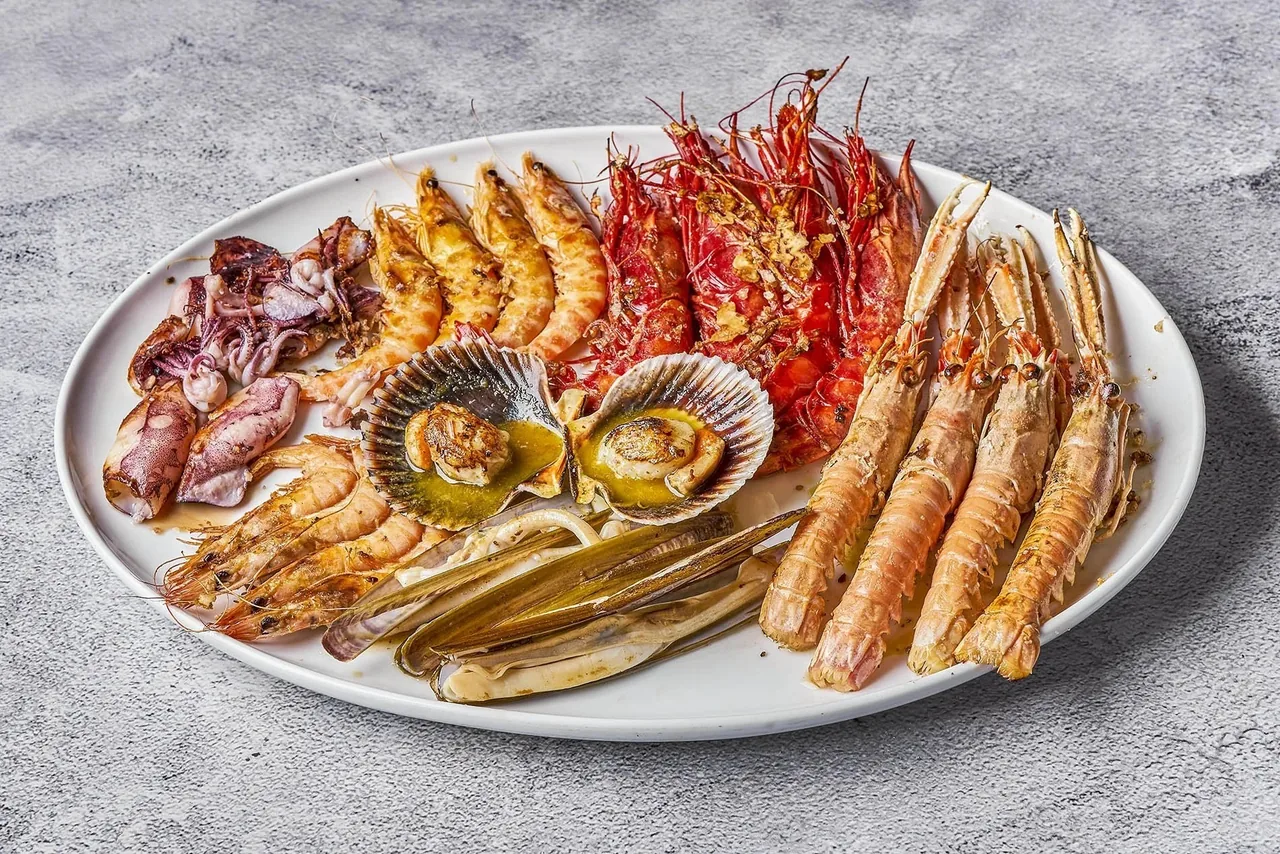 An oval platter of mixed shellfish including prawns, langoustines and scallops