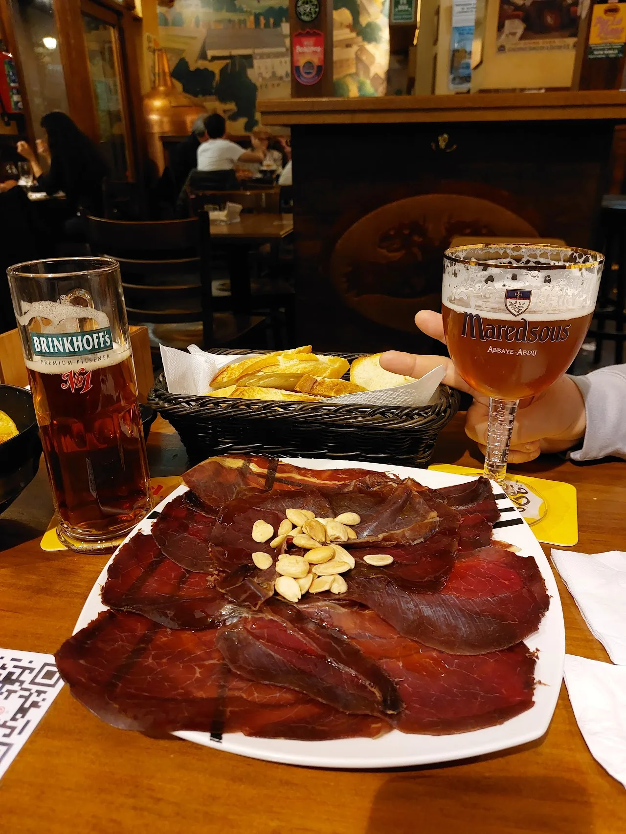 A platter of sliced smoked meat garnished with almonds