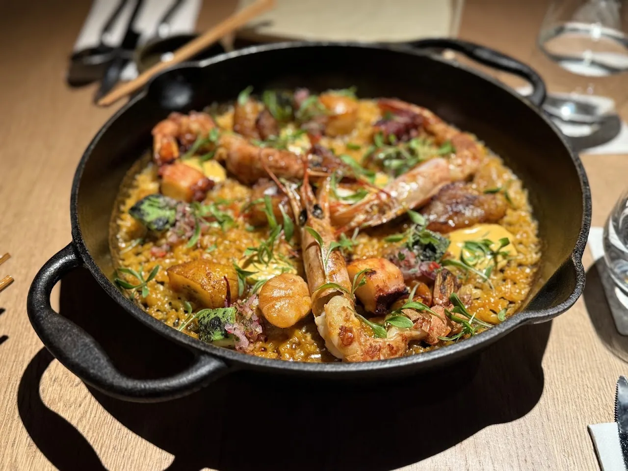 Seafood paella with prawns and mussels in a cast iron pan