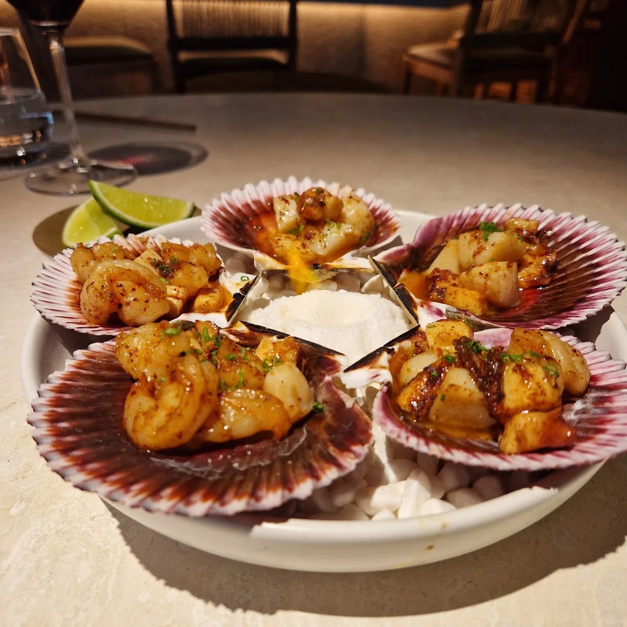 Scallops in their shells with a citrus garnish