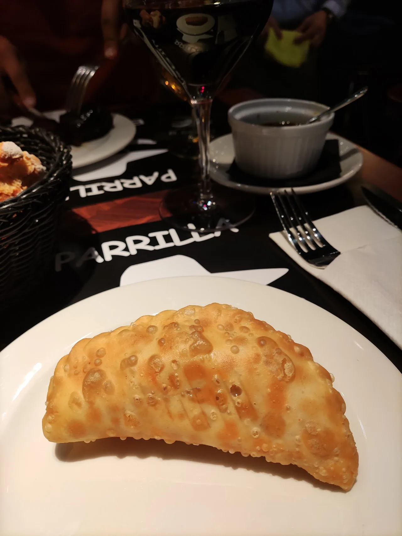 A golden fried empanada on a plate