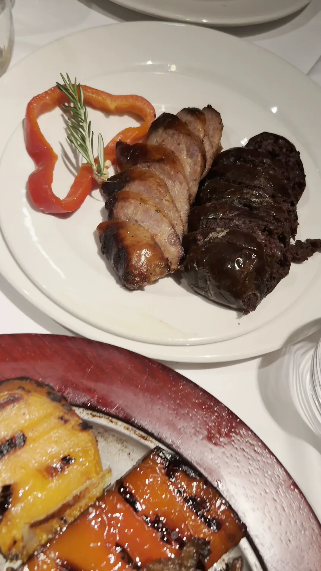 A bacon-wrapped steak garnished with rosemary
