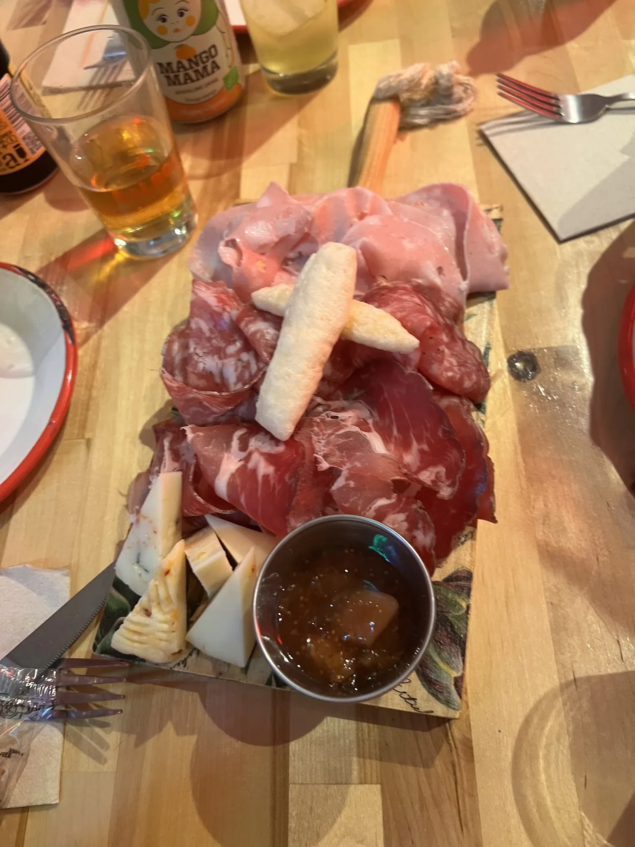 Charcuterie board with cured meats and a dipping sauce