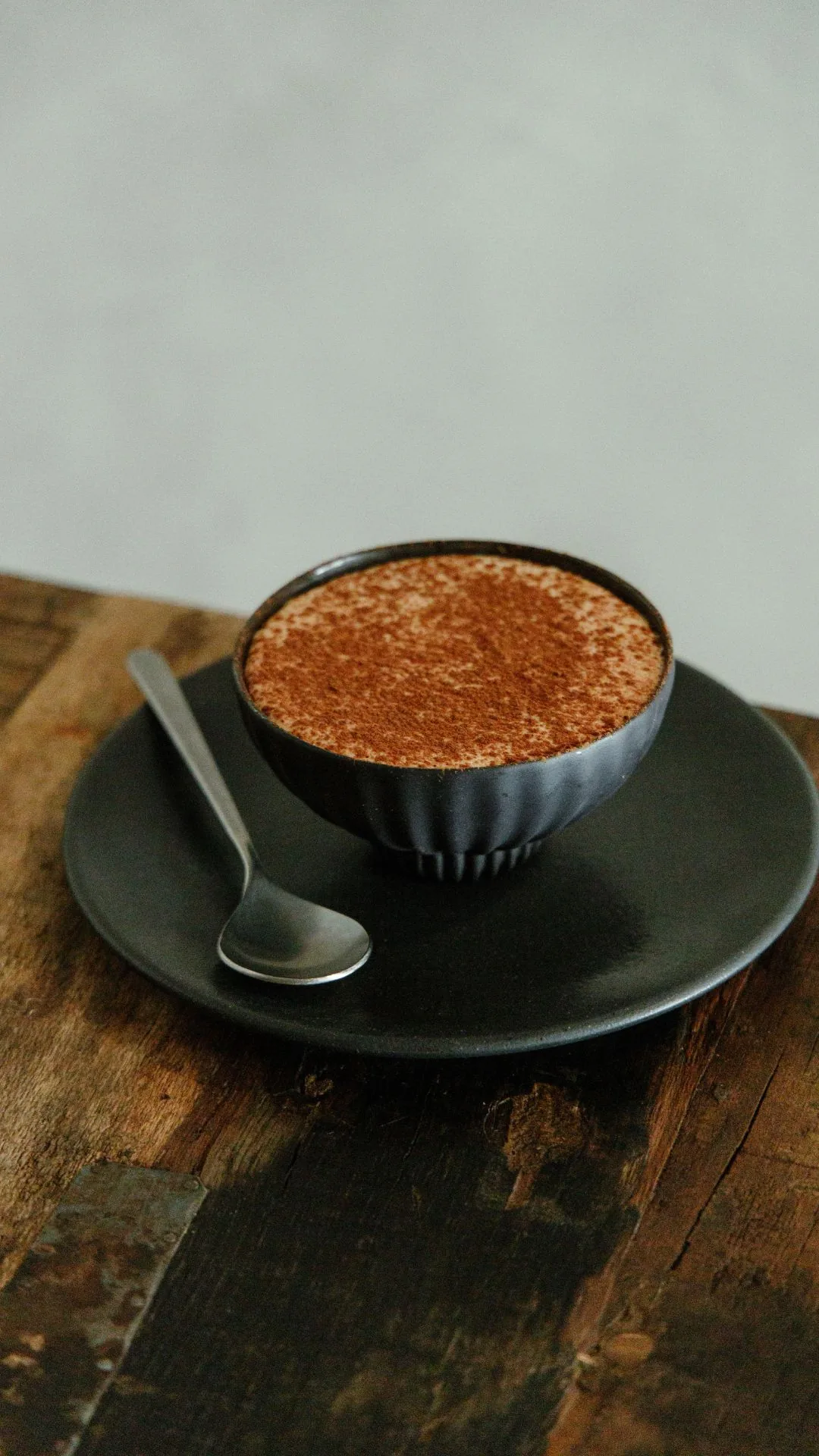 A dusted coffee dessert in a small cup