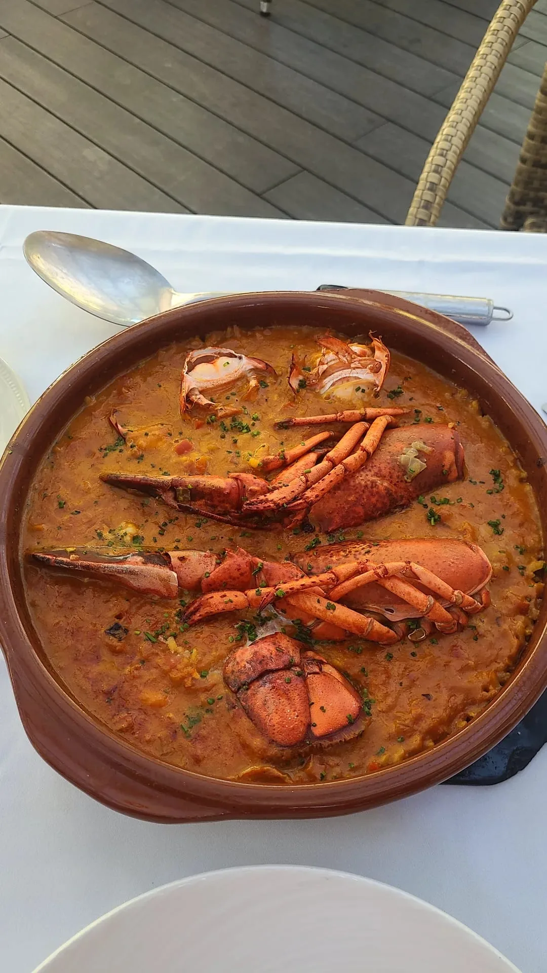 A terracotta bowl of crab claws in tomato sauce