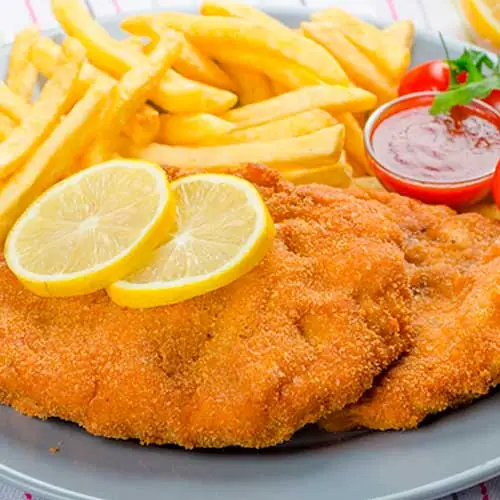 Breaded escalope with french fries, lemon slices, cherry tomatoes, and ketchup, Piolindo