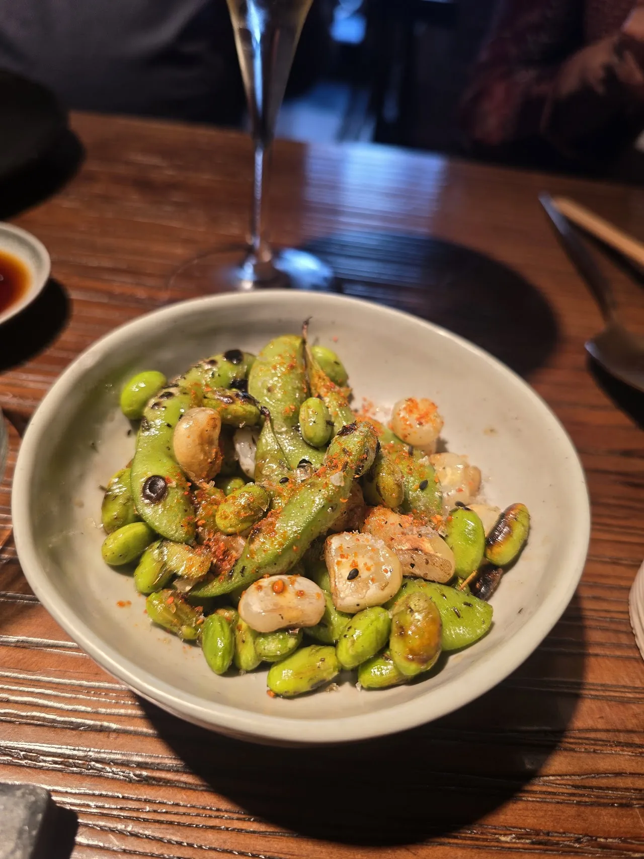 A bowl of edamame mixed with shrimp