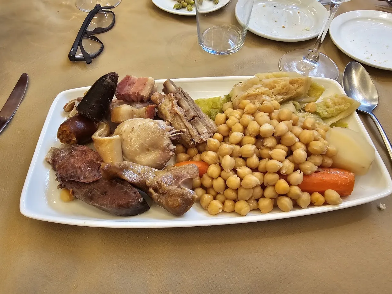 A platter of stewed chickpeas with meats and vegetables