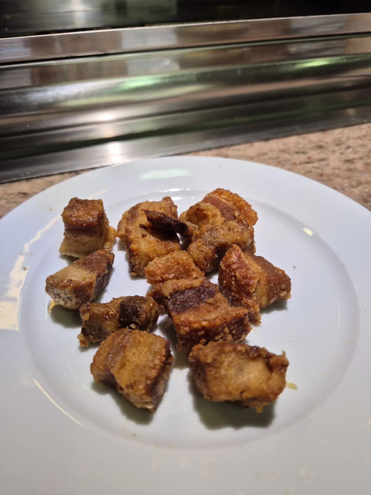 A plate of fried pork bites