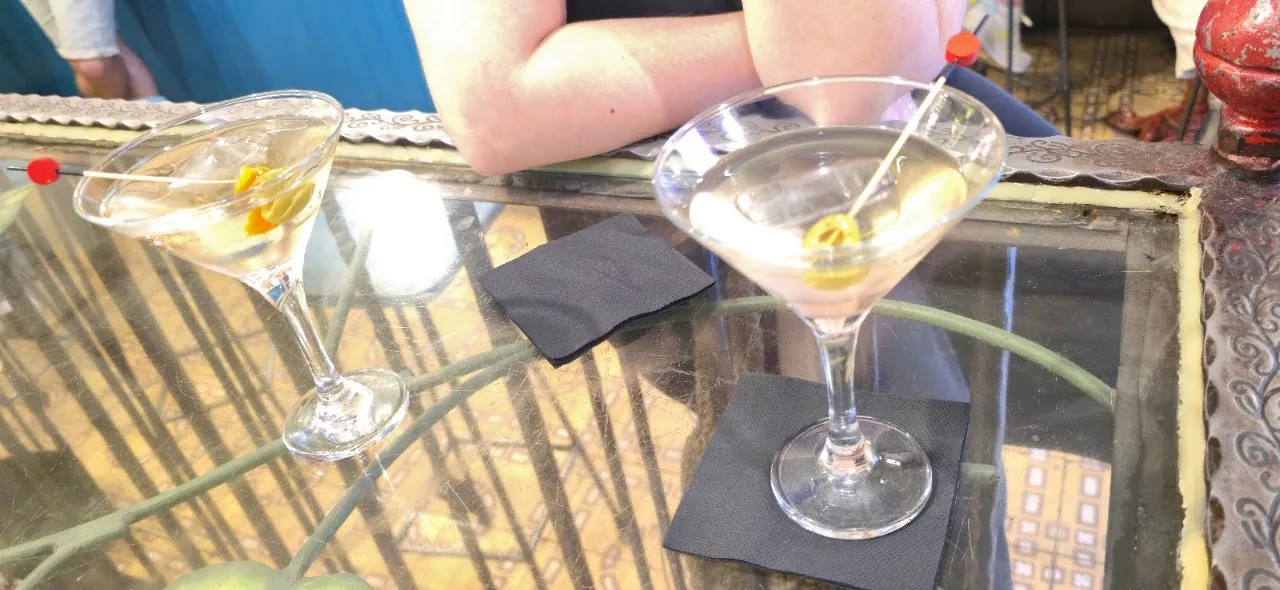 Two martini-style cocktail glasses on a table