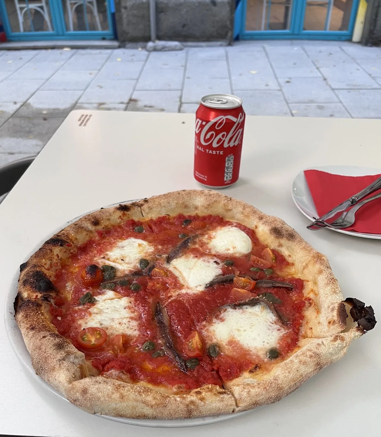 A pizza topped with tomato sauce and mozzarella