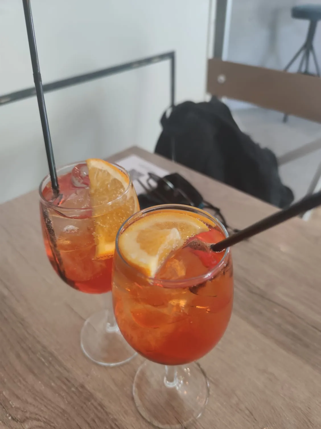 Two orange aperitif cocktails on a table