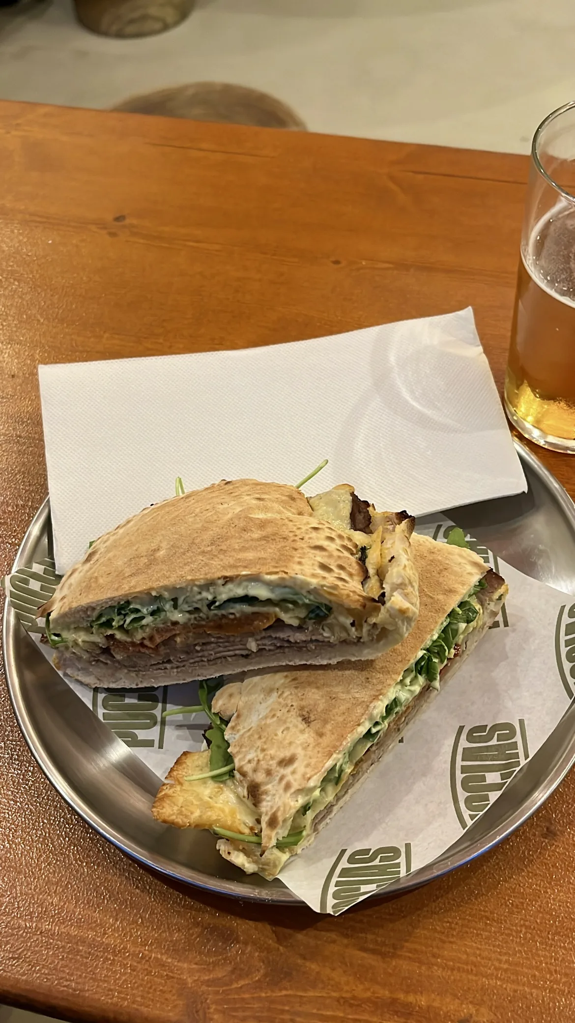 A stuffed flatbread sandwich cut in half on a plate