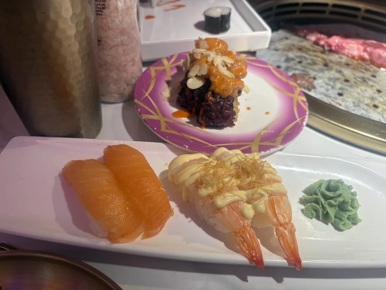 A plate of sushi rolls and shrimp nigiri