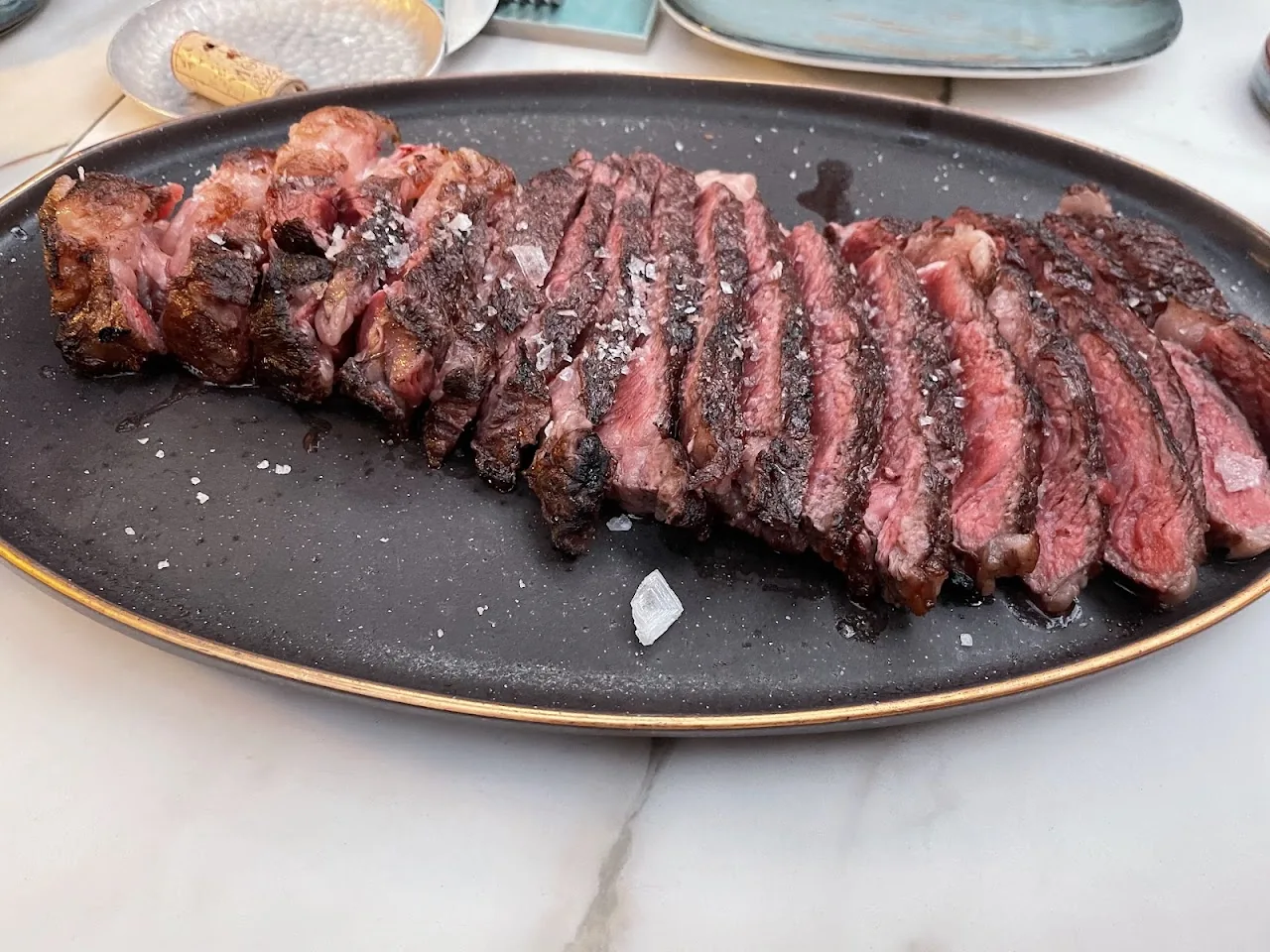 Sliced steak arranged on a plate