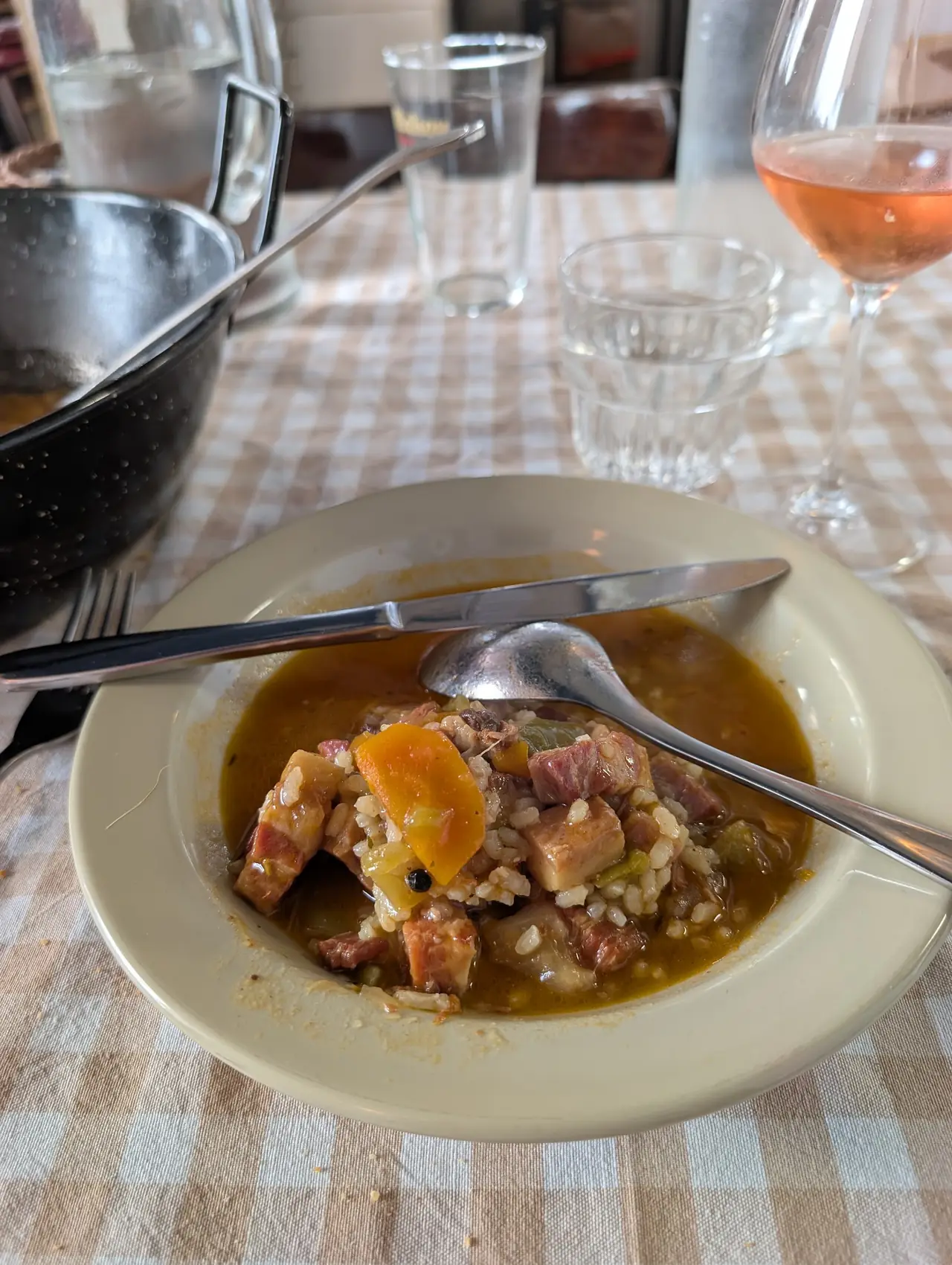 Bowl of rice stew with diced meat, carrot and gravy