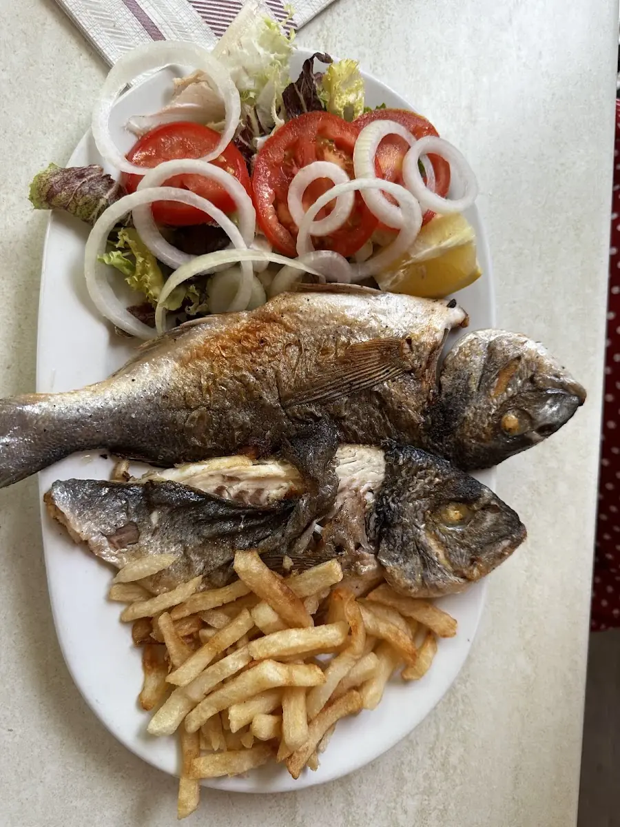 A whole grilled fish with fries at Ran de Mar