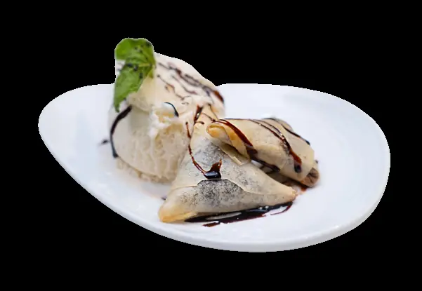 Folded dessert crepes with chocolate drizzle beside a scoop of ice cream topped with mint, Rasoi (Rasoi BCN)