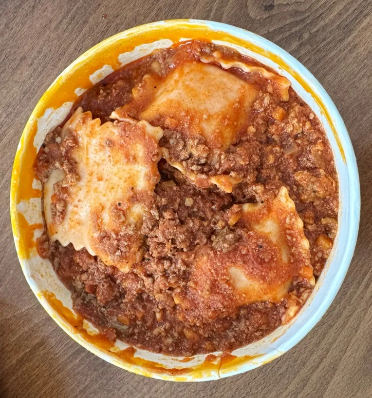 A baked pasta dish with a golden cheese crust and meat sauce