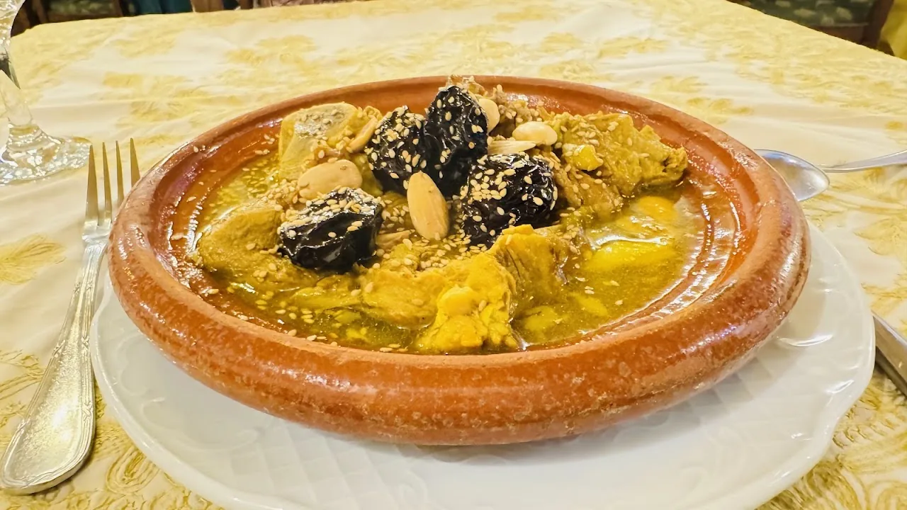 A tagine of stewed meat with prunes and toasted almonds
