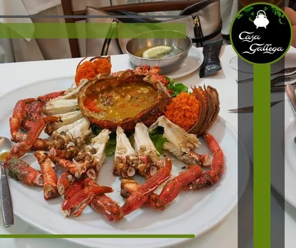 A seafood platter with king crab, spider crab, and langoustines arranged on a plate