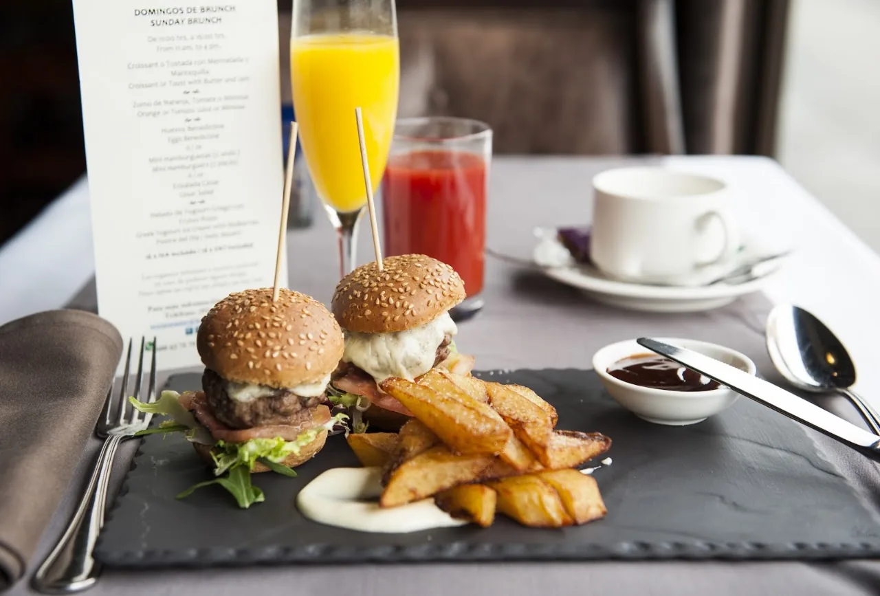 Two mini burgers with a side of fries on the table