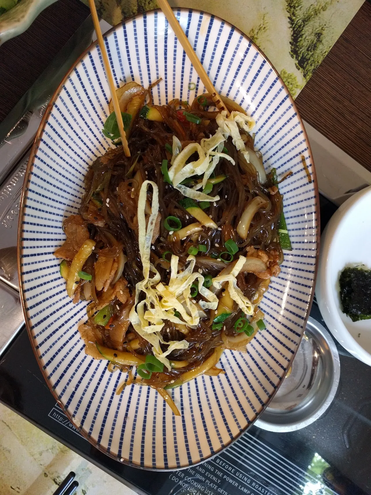 A plate of stir-fried glass noodles with vegetables