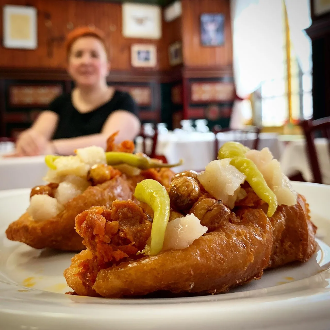 Fried chicken pieces with pickles on a plate