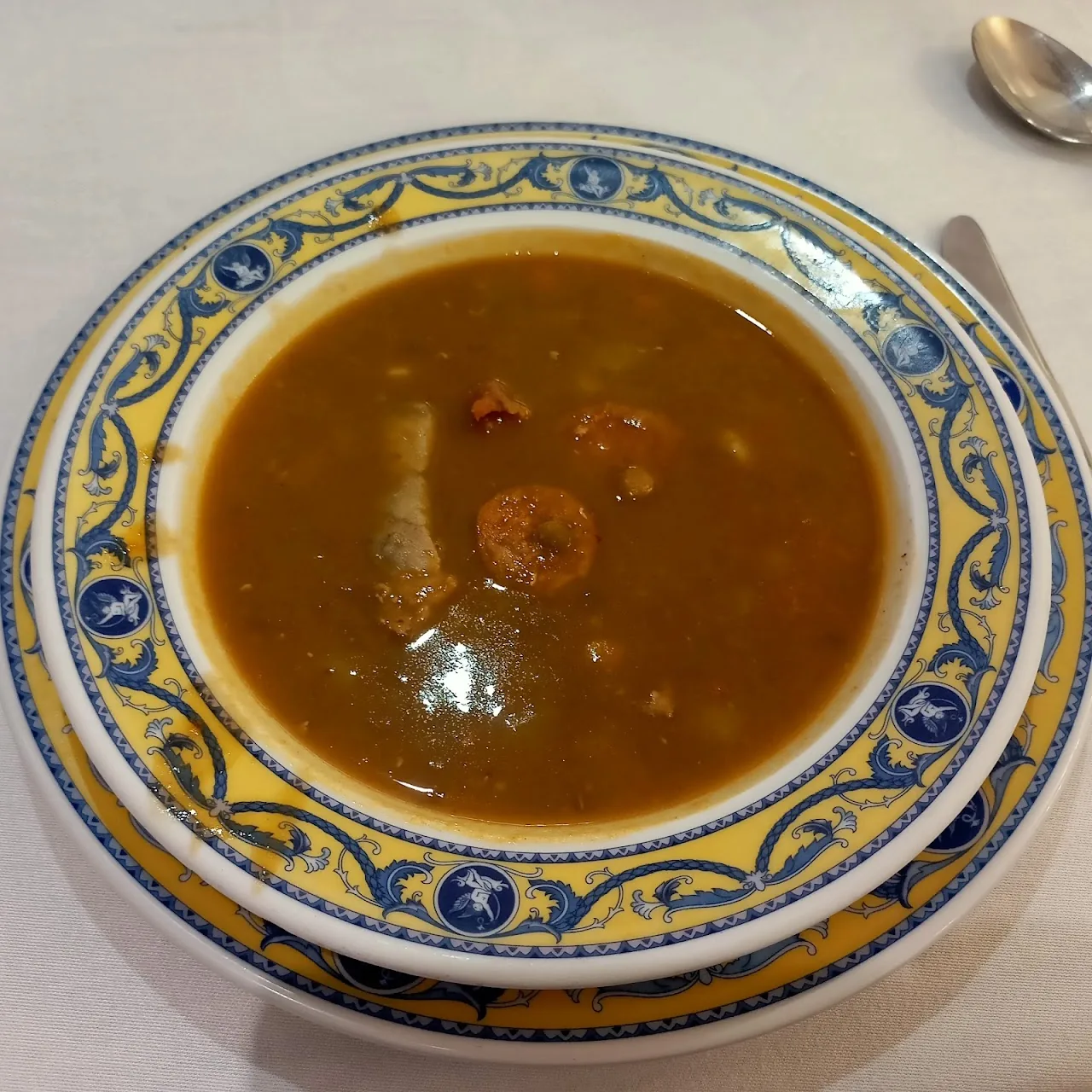 A bowl of seafood soup with shrimp