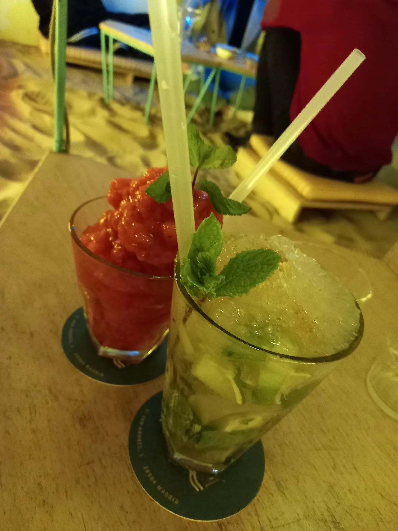 Two frozen fruit cocktails with straws
