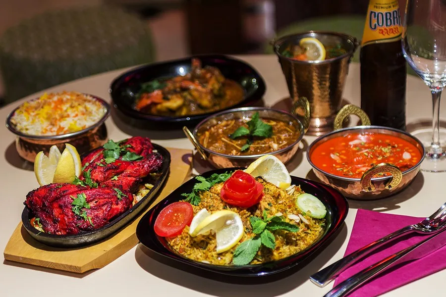 A spread of Indian curry dishes and rice on a table