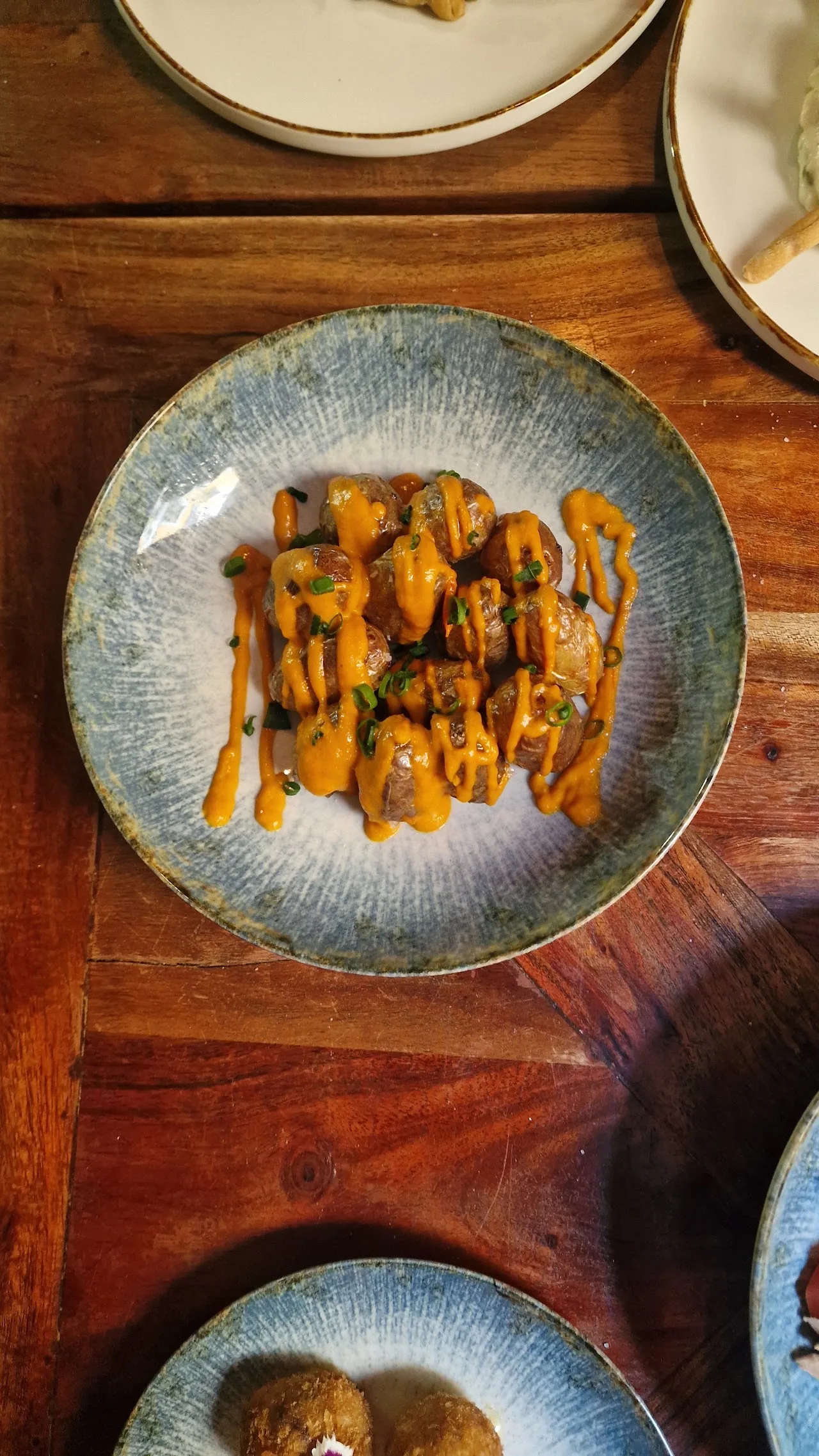 A plate topped with thin orange vegetable strips arranged in a swirl