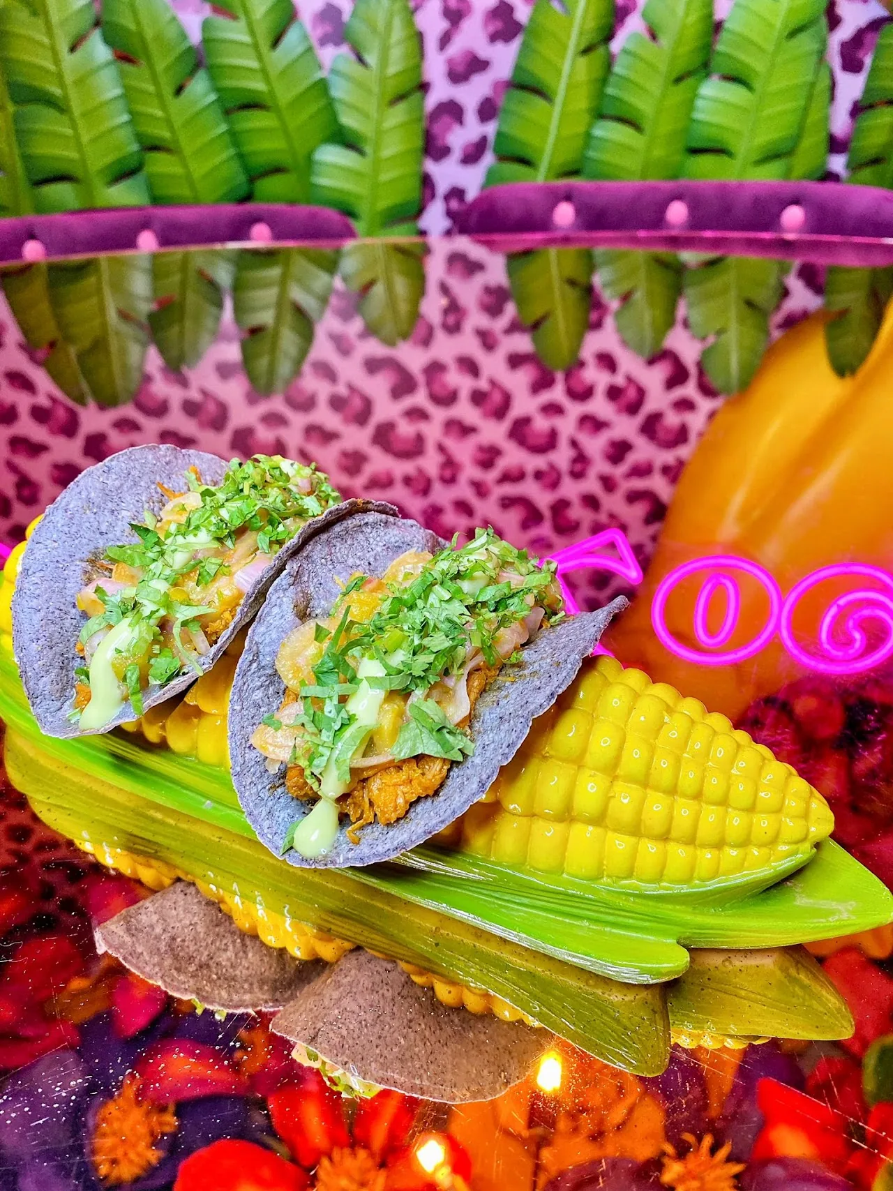 Two tacos with charred corn on a colorful plate