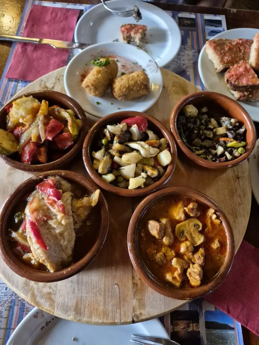A board of assorted tapas in small bowls at Sa Portassa