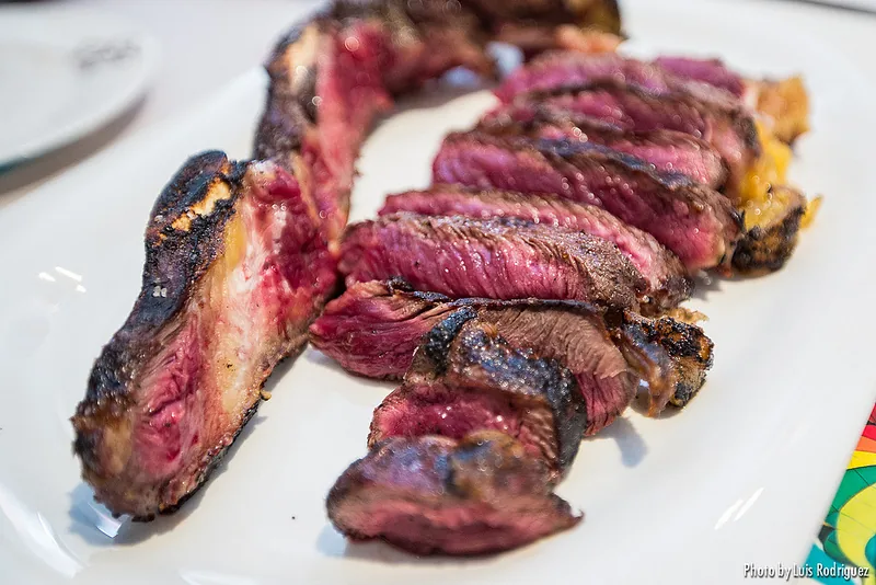 Slices of grilled txuletón steak on a plate
