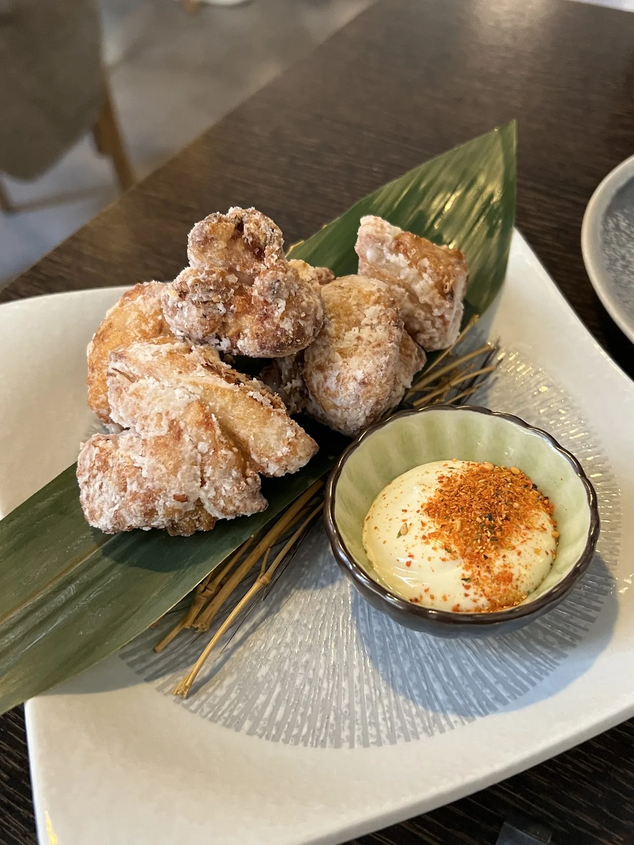 Fried karaage chicken pieces with a dipping sauce