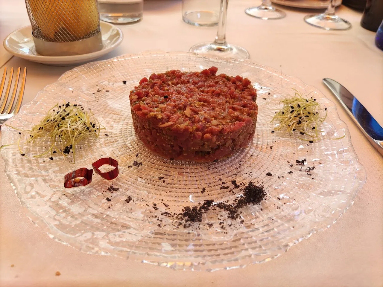 Beef tartare plated with microgreens and edible flowers