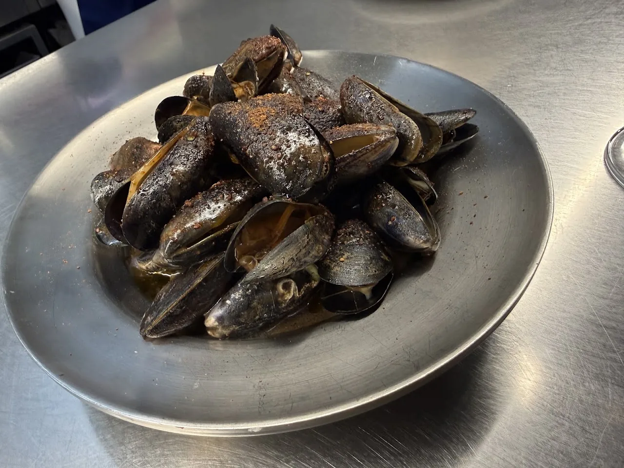 A bowl of steamed mussels in their shells