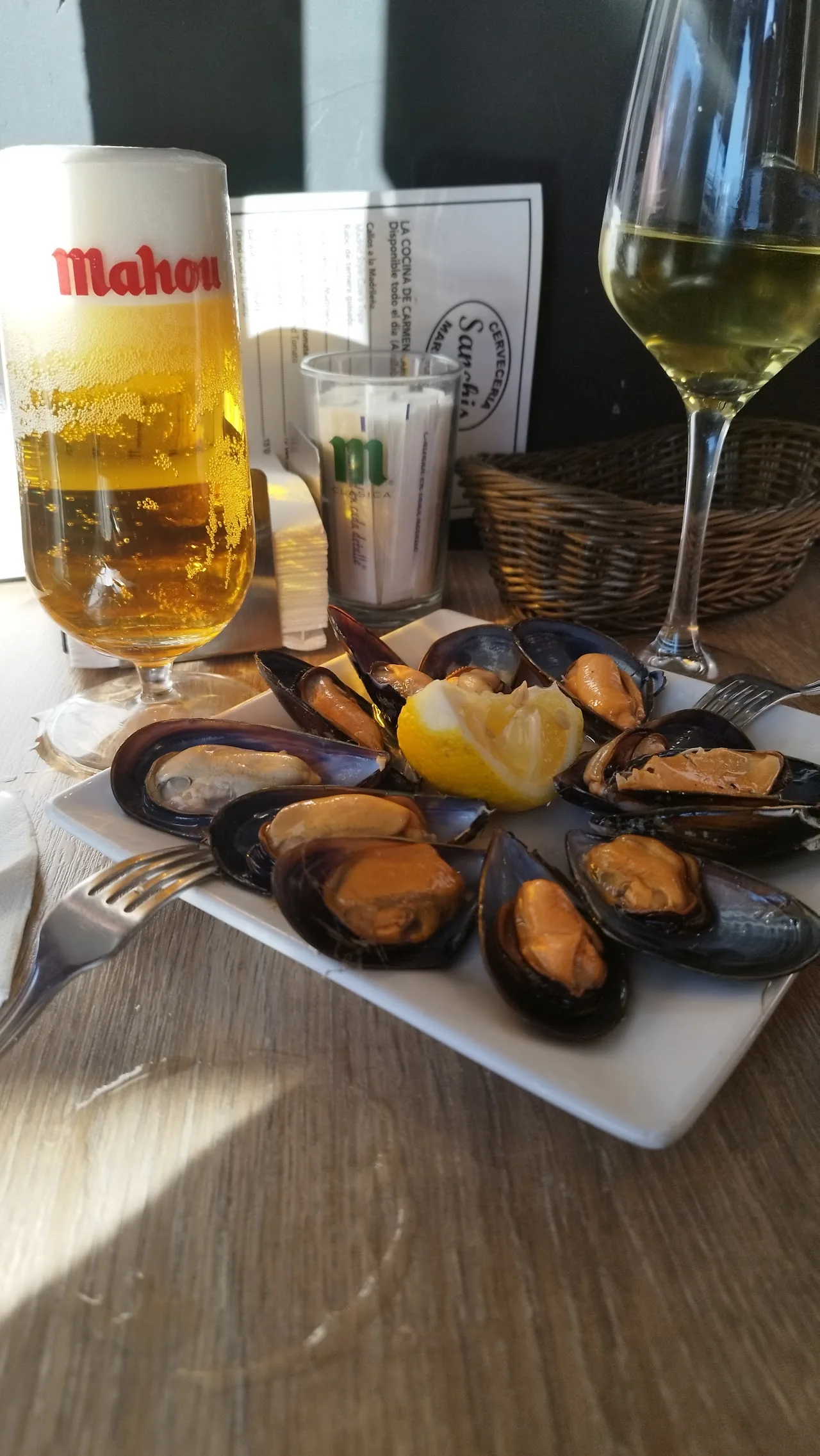 Mussels on the half shell with a glass of white wine and beer