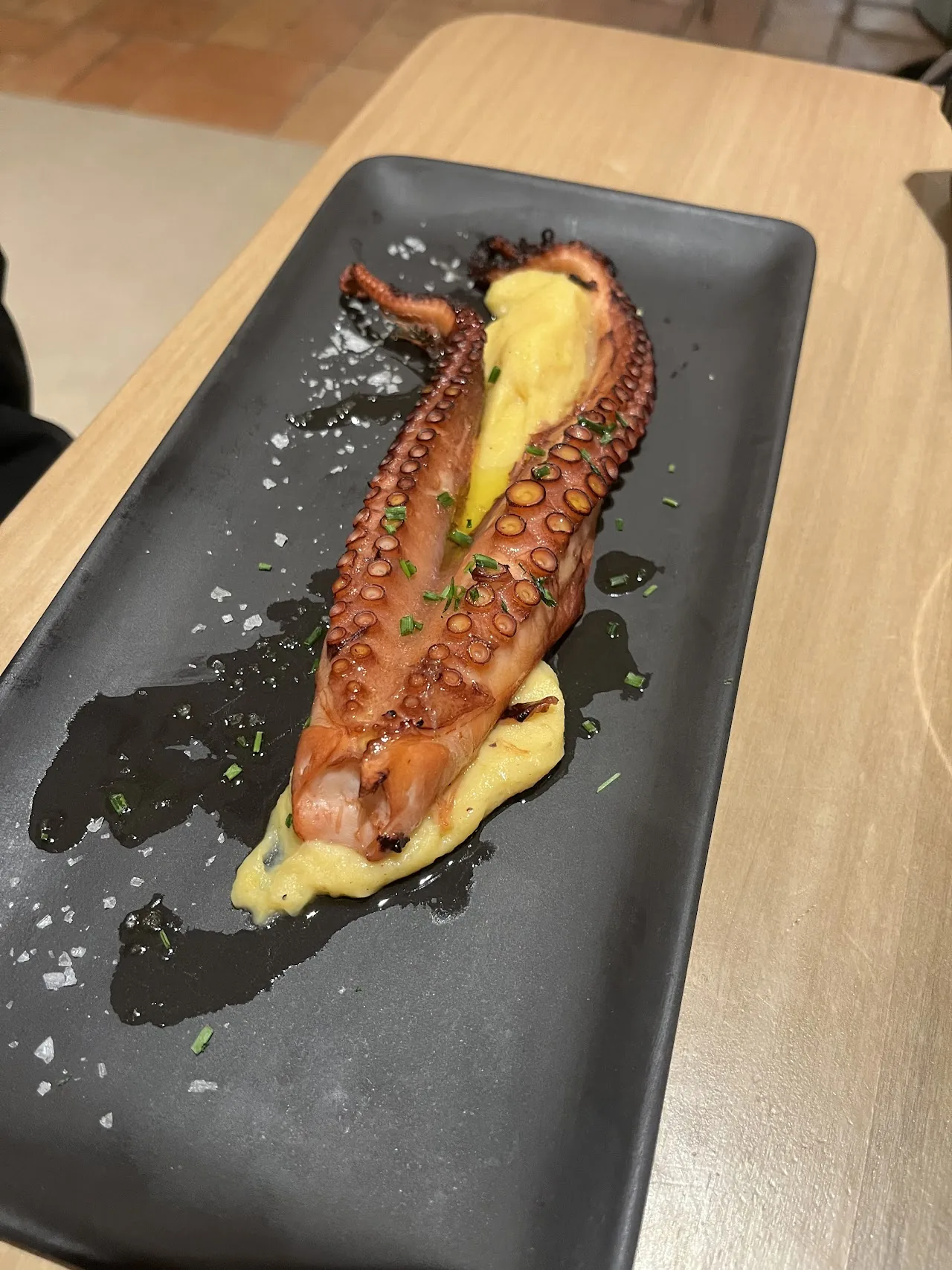 Grilled octopus slices on a bed of puree