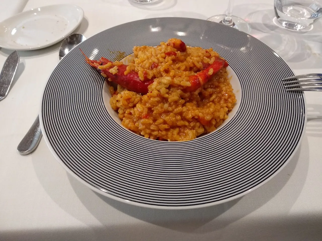 A plate of orange-hued seafood paella