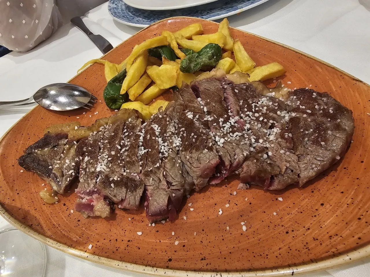 A grilled steak with sautéed vegetables on a wooden board