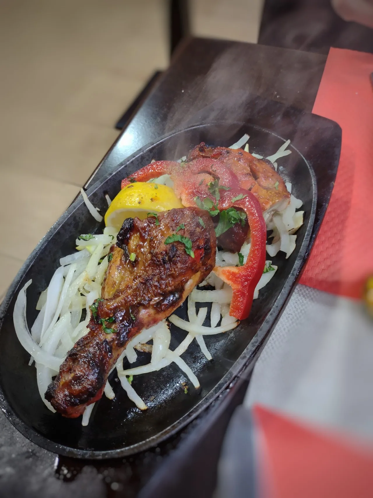 Sizzling tandoori chicken with peppers and onions