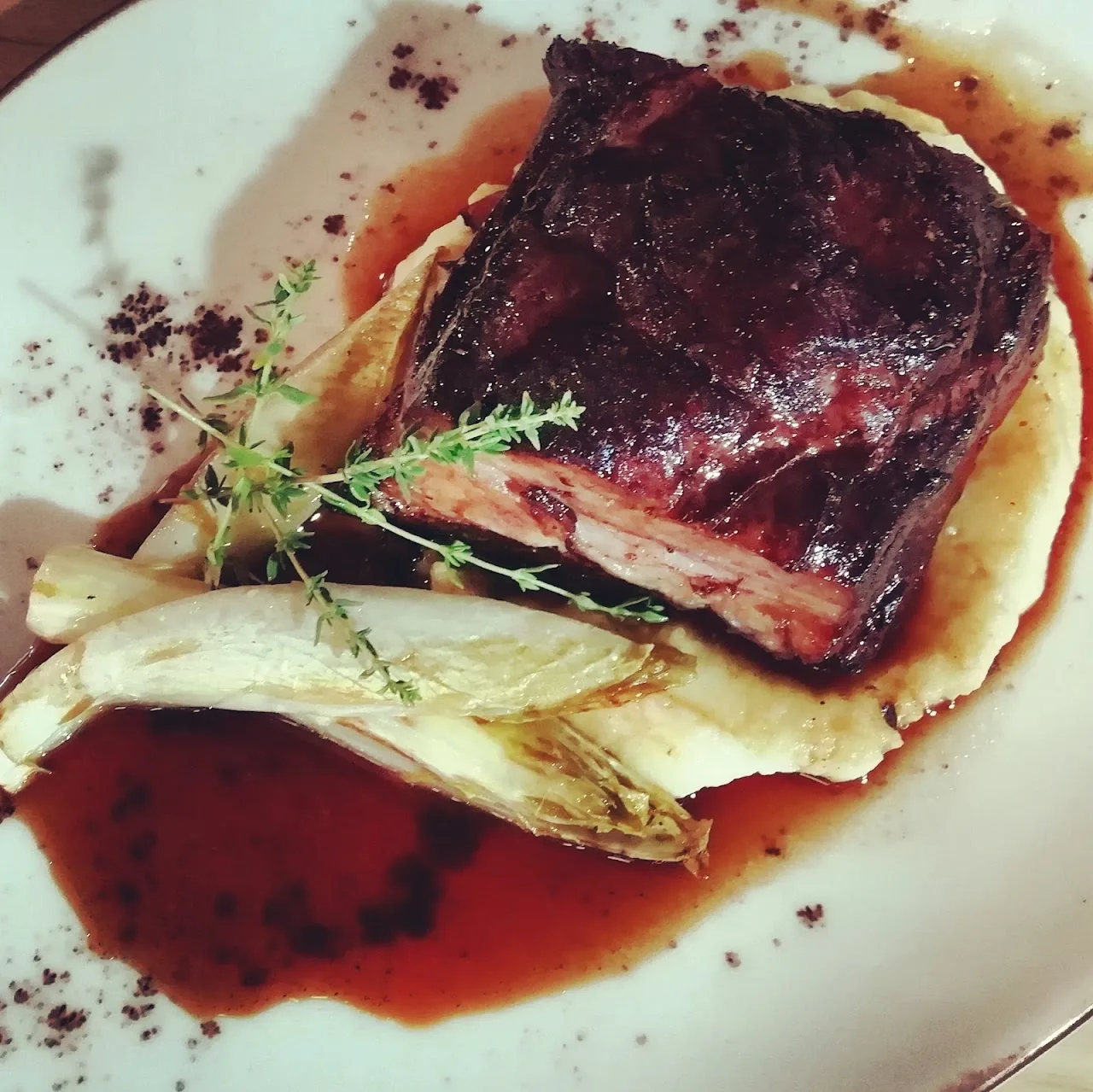 A charred short rib served on flatbread