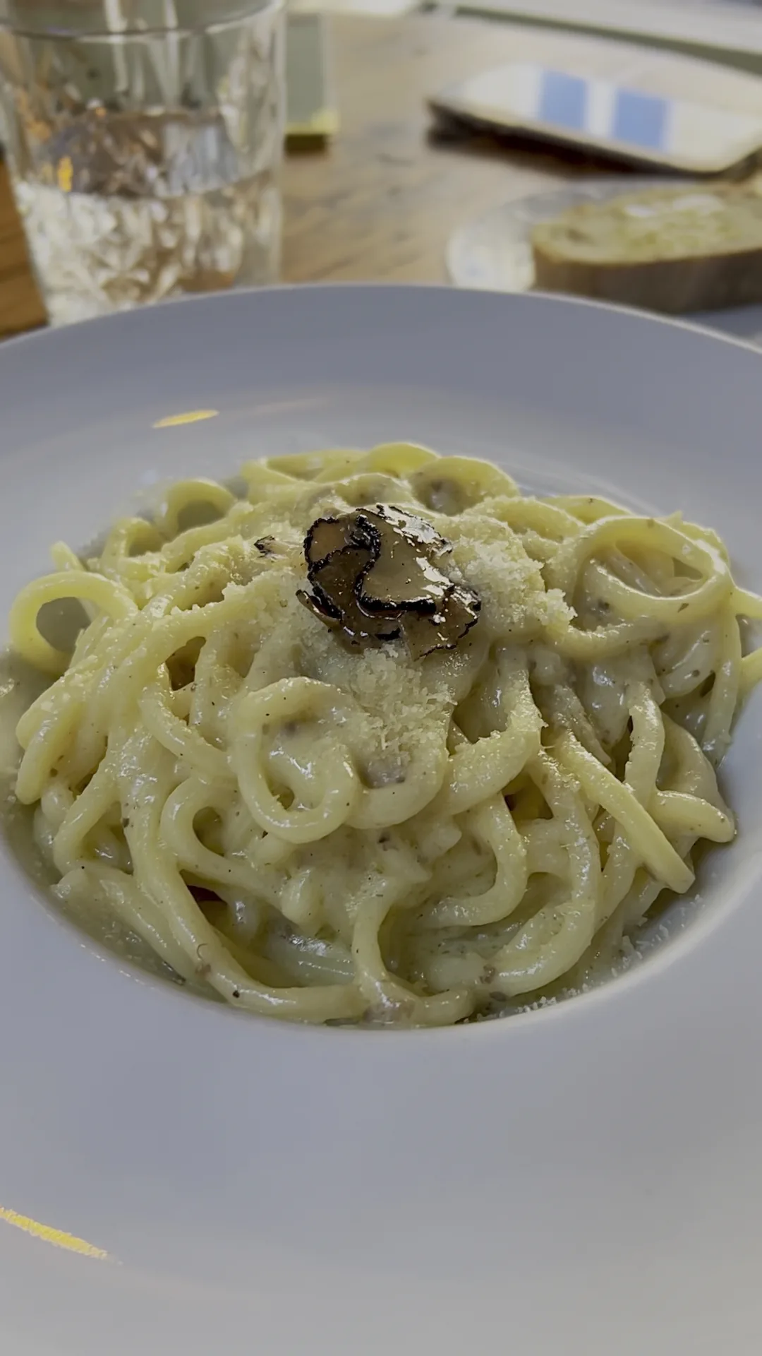 A bowl of pasta tossed with shaved black truffle