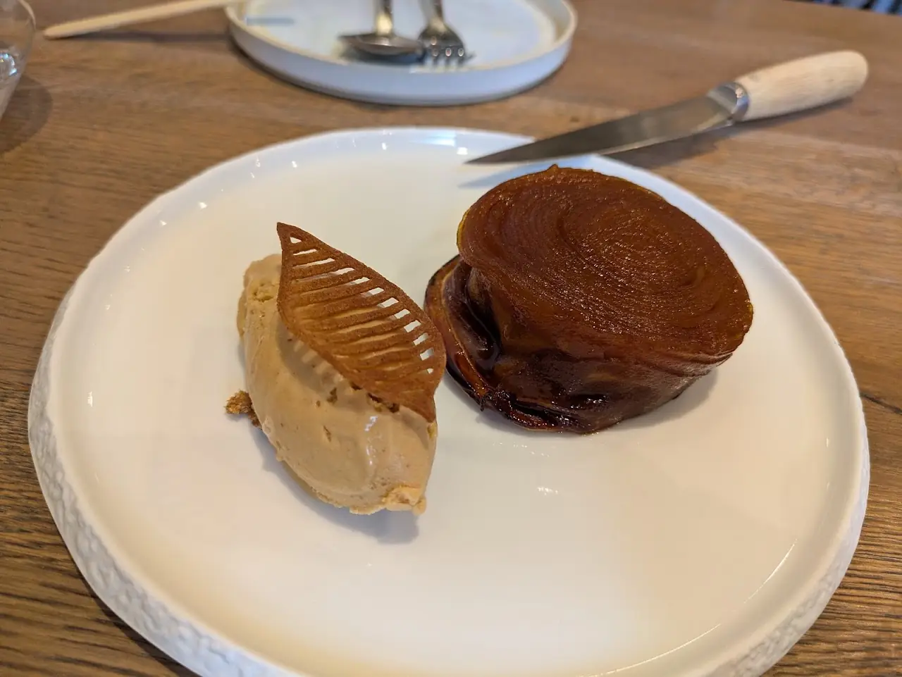 Chocolate fondant dessert with a thin caramel tuile leaf