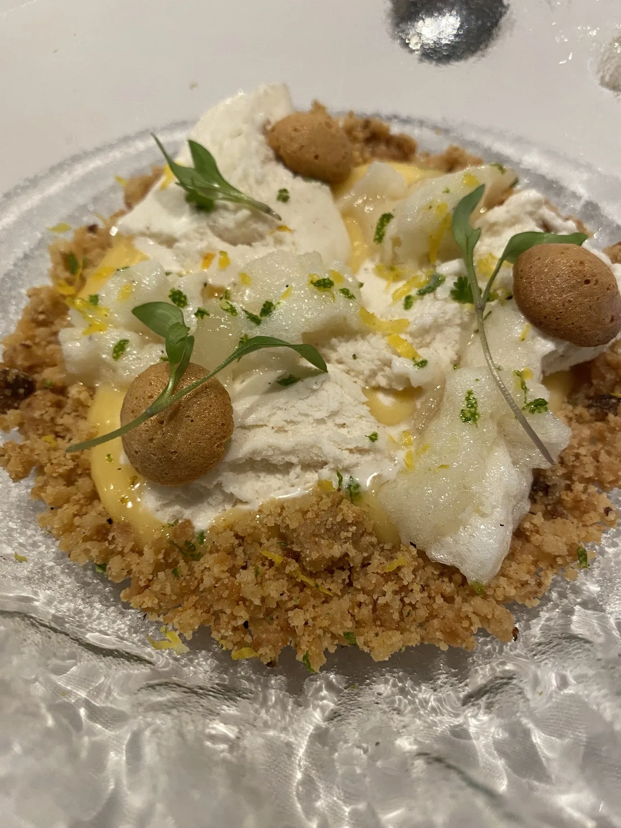 A creamy dessert with a crumble base and citrus garnish