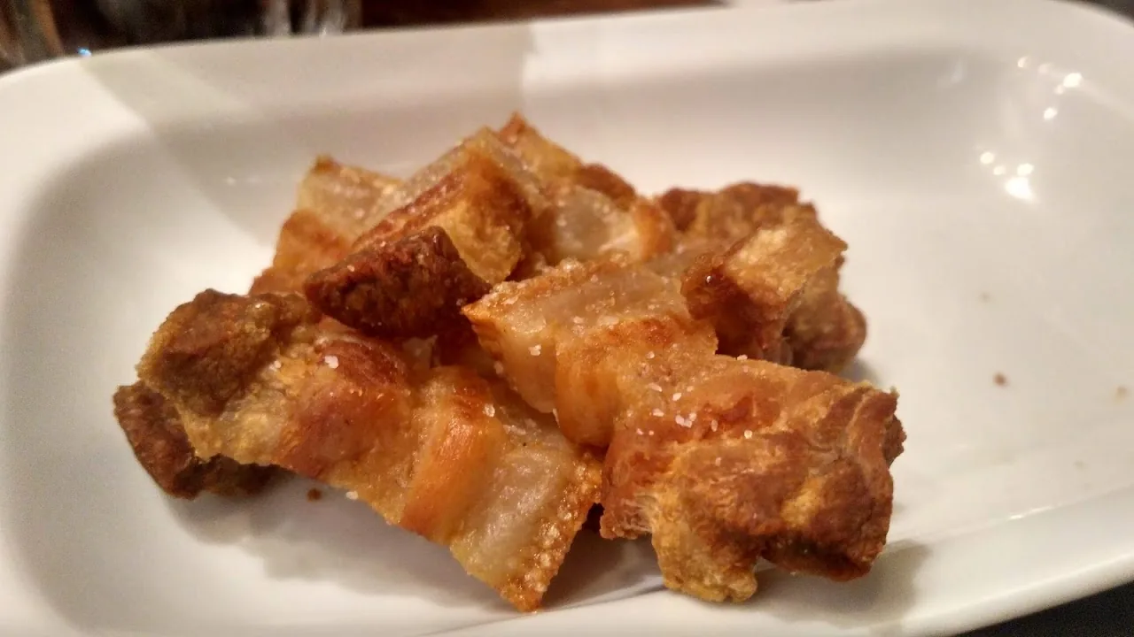 A plate of crispy pork belly bites