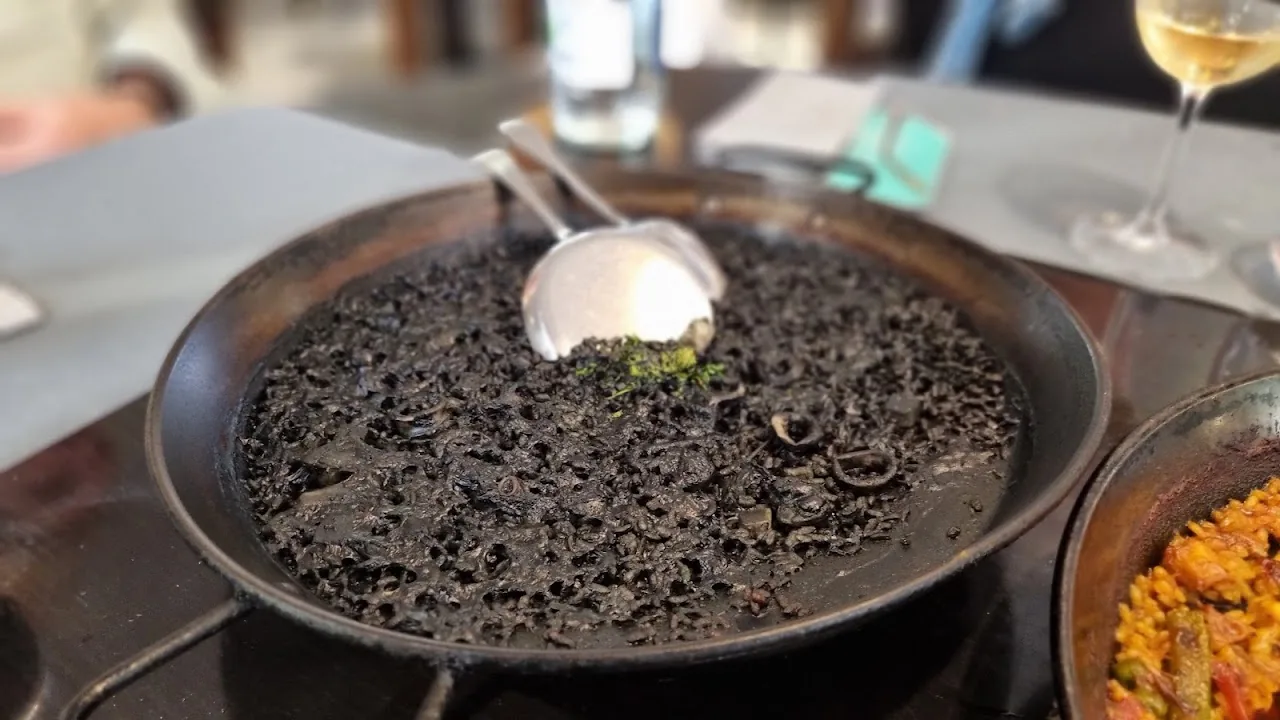 A pan of black rice topped with a poached egg