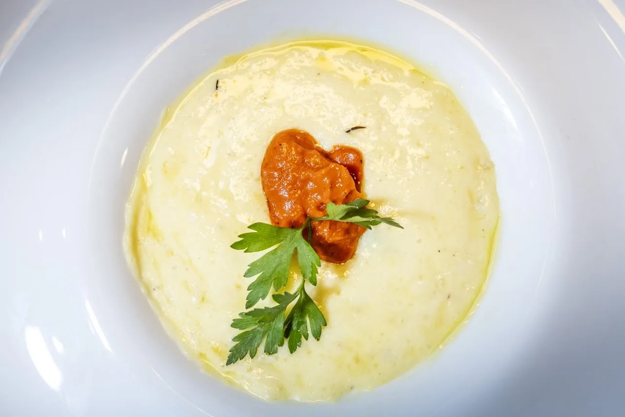 A creamy risotto topped with a tomato relish and herb garnish